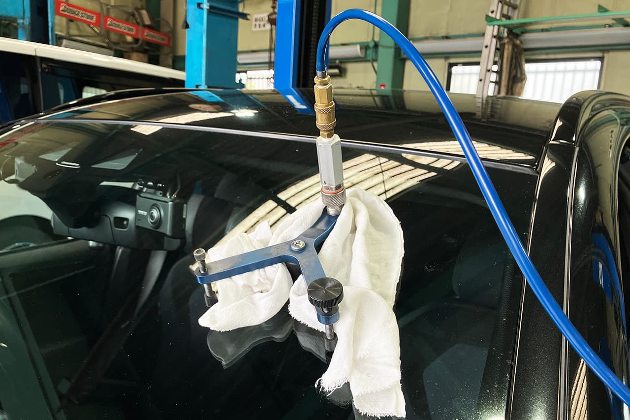 黒い車のガラス修理をしている様子